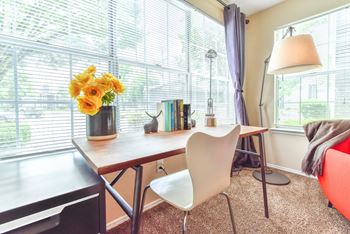 a home office with a large window and a desk with a chair at Riverset Apartments, Memphis, 38103